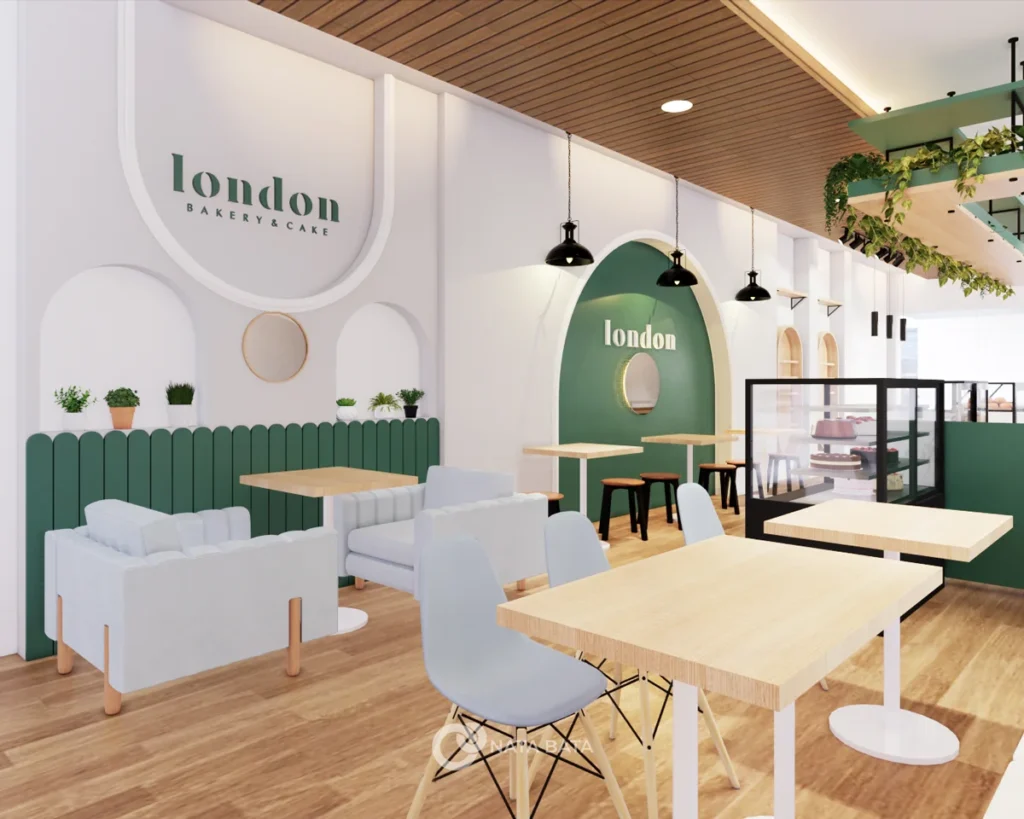 Area seating London Bakery dengan kursi sofa dan aksen hijau di dinding