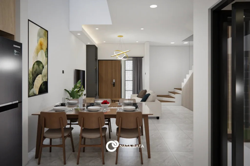 Interior ruang makan terbuka dengan meja kayu panjang, kursi minimalis, ruang keluarga modern, serta tangga menuju lantai atas